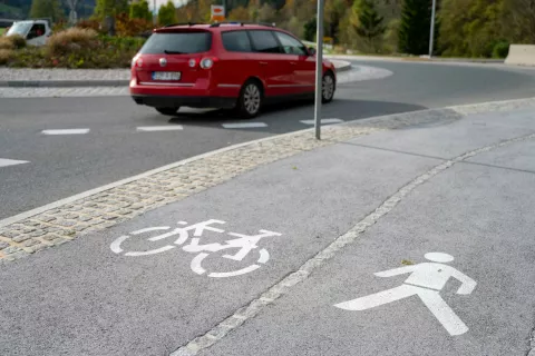 Simbolična fotografija pešec, kolesar in avto. / Foto: Nik Bertoncelj