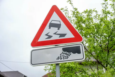 Simbolična fotografija prometni znak opozorilo o mokri cesti / Foto: Nik Bertoncelj