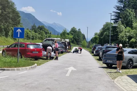 Parkirišče v Mojstrani, kjer lahko obiskovalci parkirajo vozila, in pot v dolino Vrata nadaljujejo z organiziranim prevozom / Foto: Suzana P. Kovačič